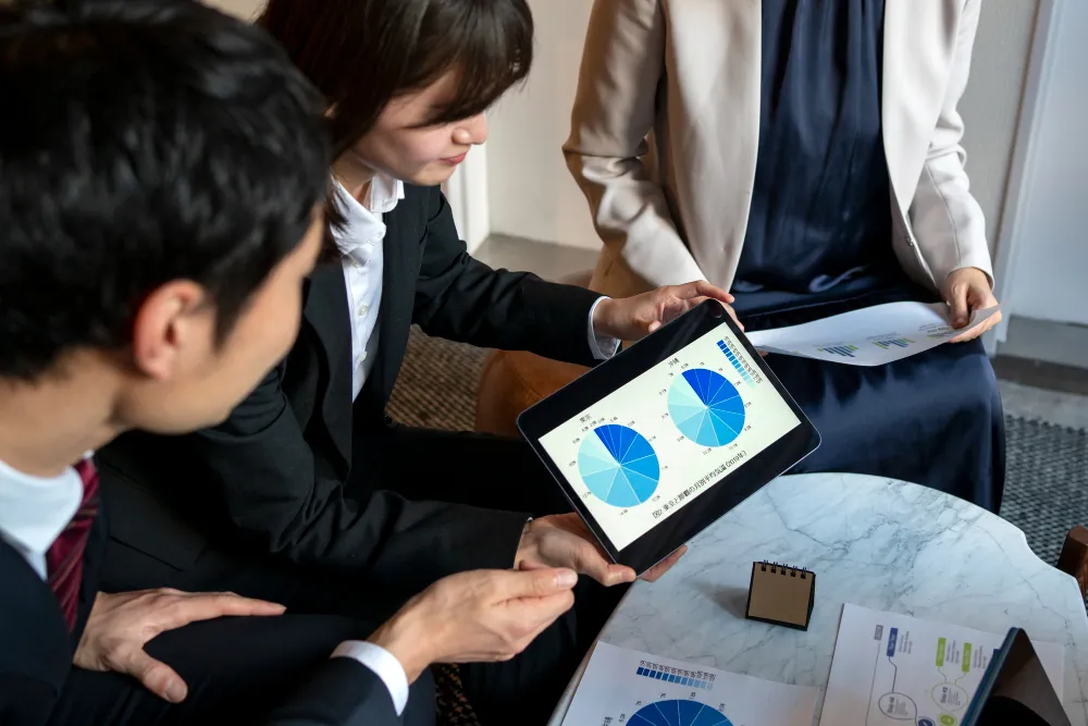 Business team analyzing financial data on a tablet